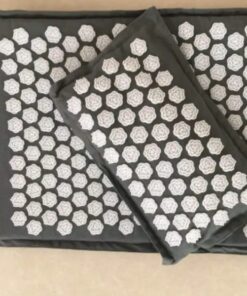 lat lay of a charcoal black linen acupressure mat and pillow, highlighting the full pressure-point surface for relaxation and recovery use